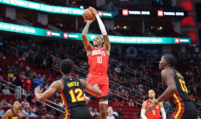 Rockets forward Jabari Smith Jr. (10) shoots the ball as Atlanta Hawks forward De'Andre Hunter (12) defends during the first quarter at Toyota Center.